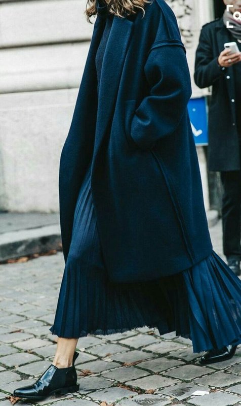 Long oversized coat combined with a pleated long skirt