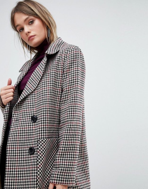 Girl in a coat with a print goose foot