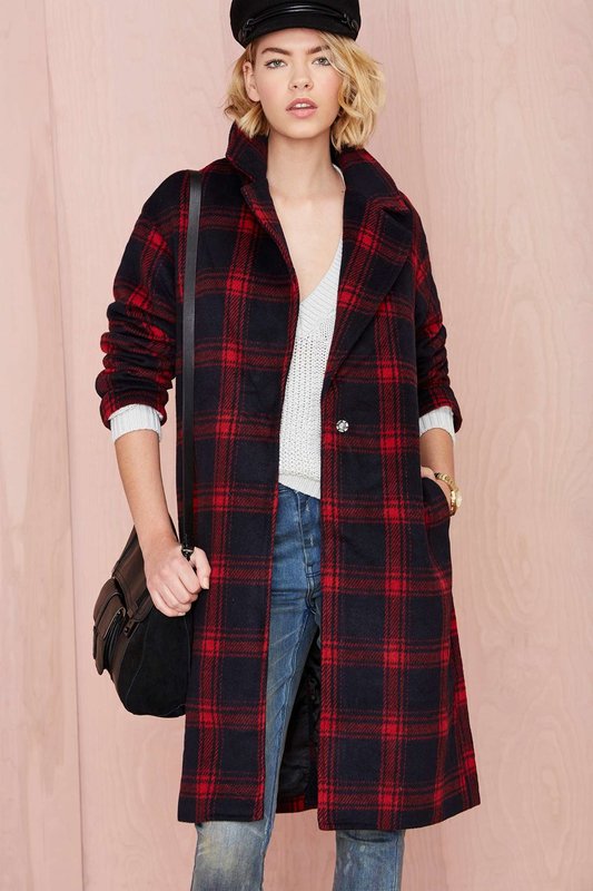 Girl in a coat in a large cage