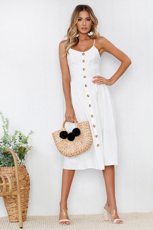 White dress with buttons along the entire length of the outfit White dress with buttons along the entire length of the outfit