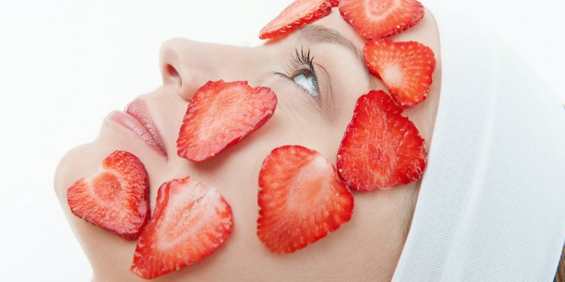 Girl with a strawberry mask on her face Girl with a strawberry mask on her face