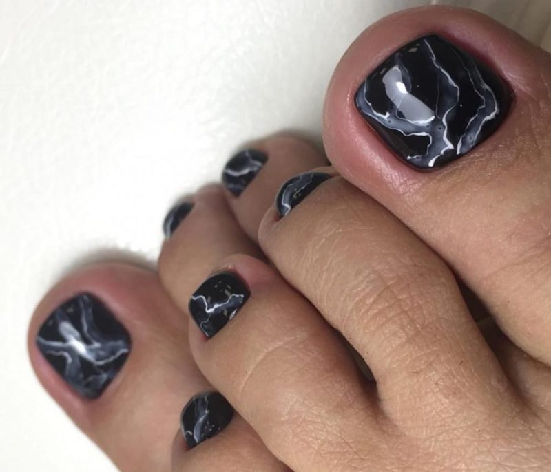 Black gel polish in marble technique Black marble