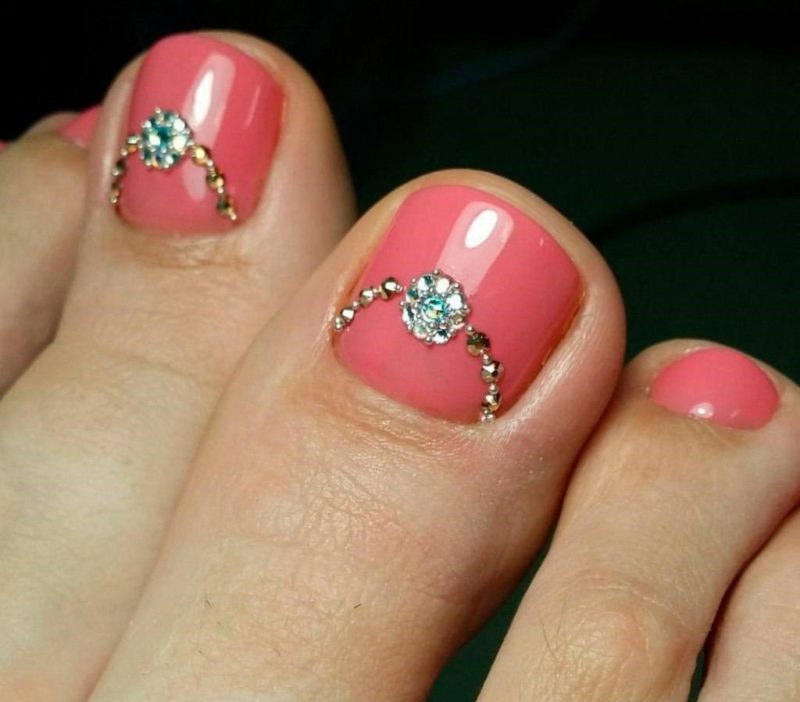 Coral pedicure with rhinestones Coral color with rhinestones