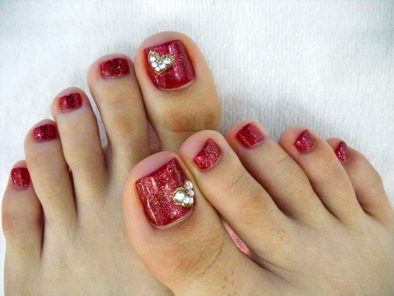 Red gel polish with glitter and rhinestones Red with glitter