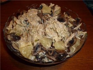 Salad with chicken, mushrooms and pineapple with curry