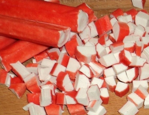 Salad of crab sticks and pineapple