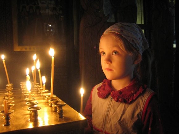 Child prays in church
