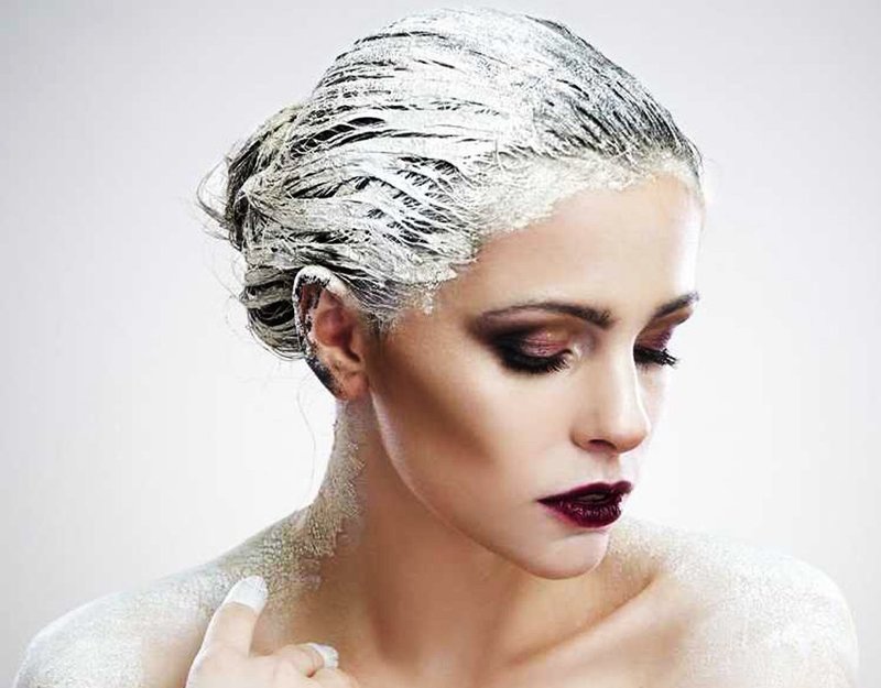 Girl with a clay mask on her hair