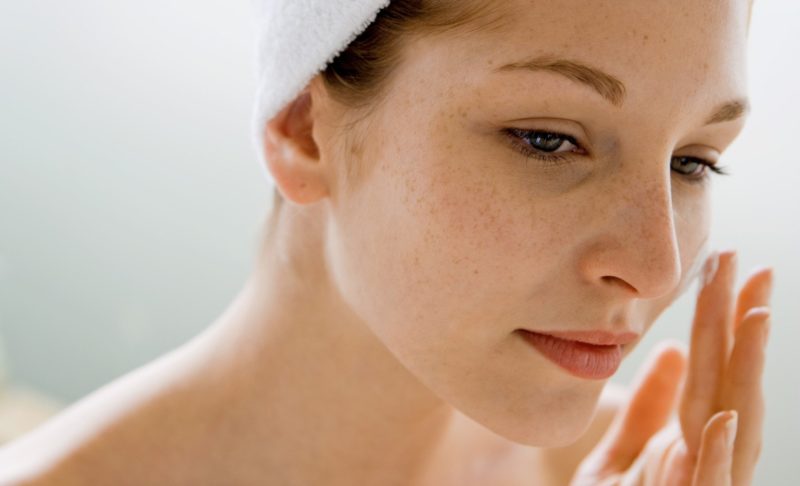 Applying whitening cream Applying whitening cream