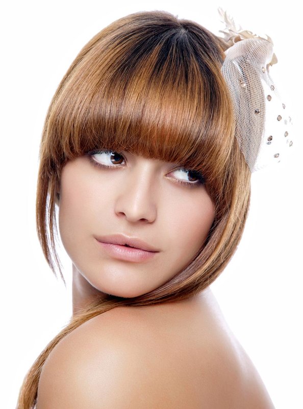 Girl with an oval face and curved bangs