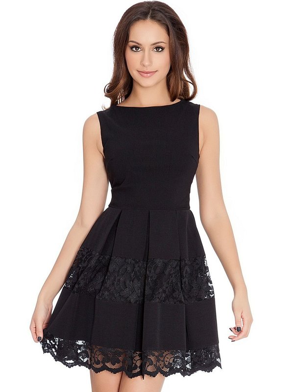 Girl in a black cocktail dress with lace on a skirt Girl in a black cocktail dress with lace on a skirt