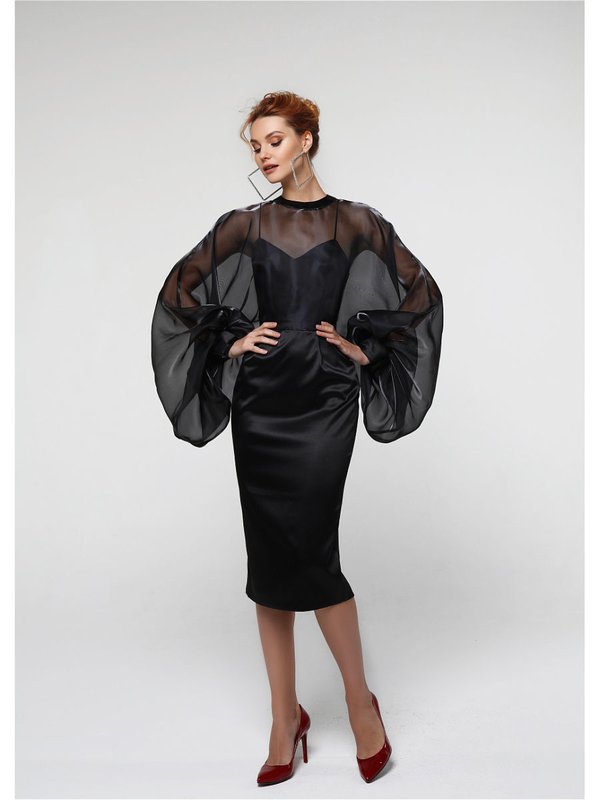 Girl in a cocktail dress with long magnificent sleeves. Girl in a cocktail dress with long magnificent sleeves.