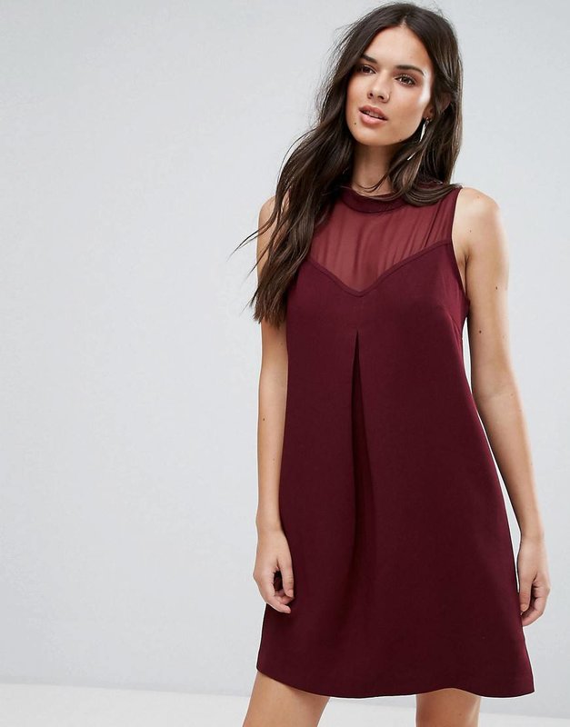 Girl in a burgundy A-line cocktail dress with a cut-out heart Girl in a burgundy A-line cocktail dress with a cut-out heart