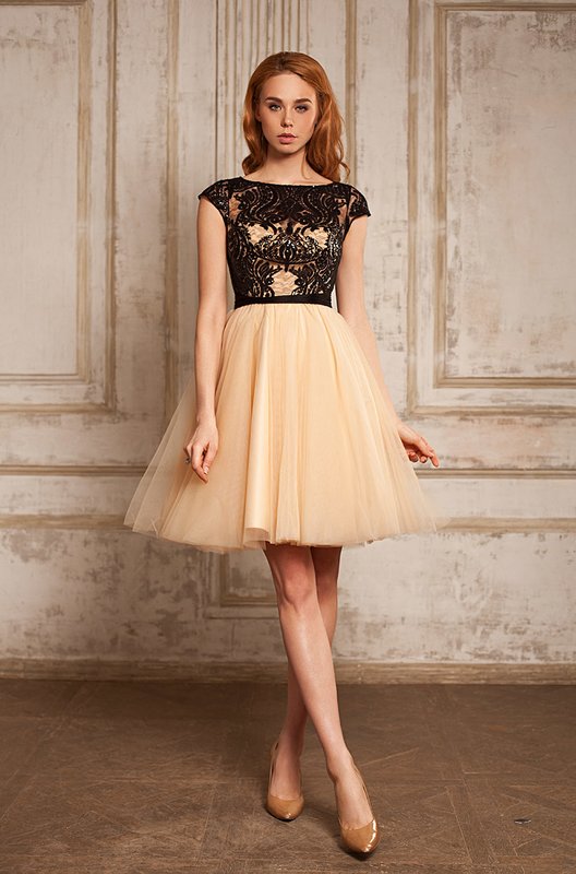 Girl in a beige cocktail dress with a black top. Girl in a beige cocktail dress with a black top.