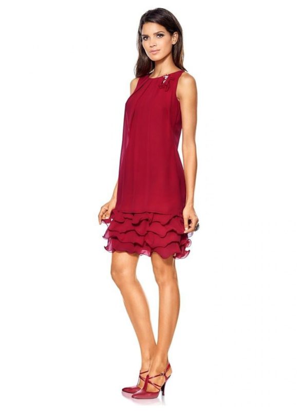 Girl in a cocktail dress with ruffles on the hem Girl in a cocktail dress with ruffles on the hem