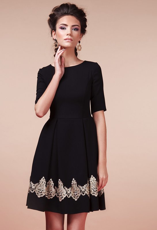 Girl in a black A-line cocktail dress with lace insert Girl in a black A-line cocktail dress with lace insert