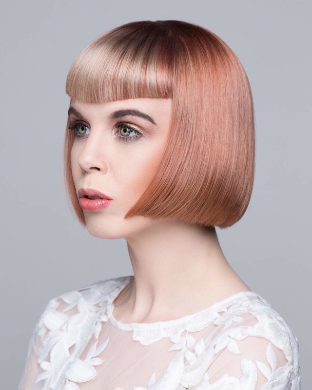 Girl with curly bang in the shape of an arch