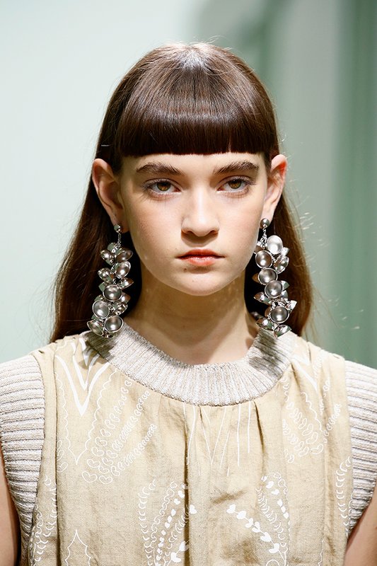 A girl with a square face and a straight bang