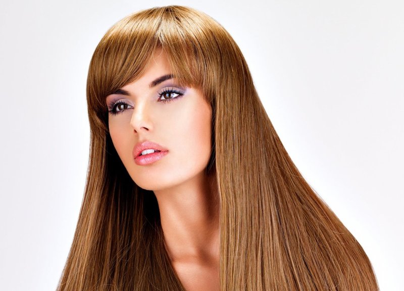 Girl with a haircut on long hair with a bang