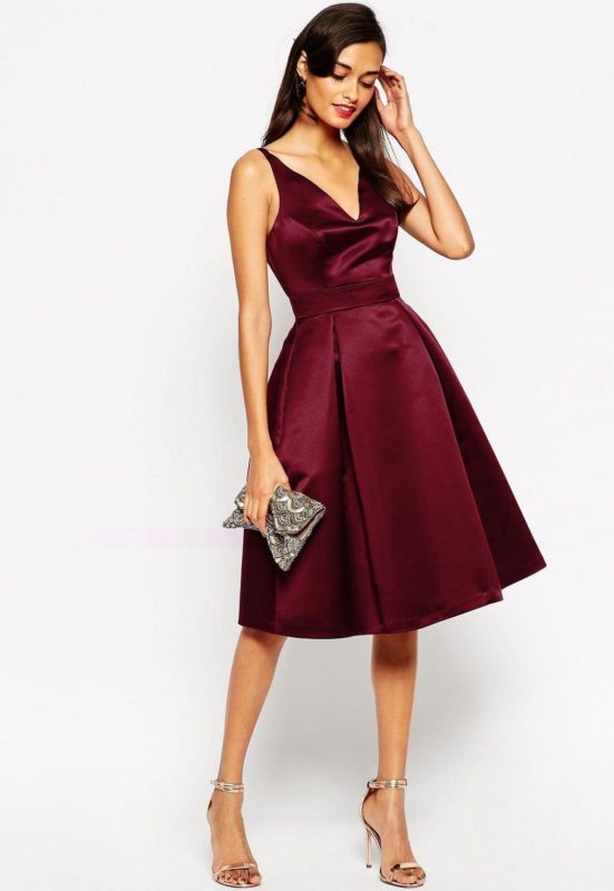 Girl in a burgundy cocktail dress with a deep neckline Girl in a burgundy cocktail dress with a deep neckline