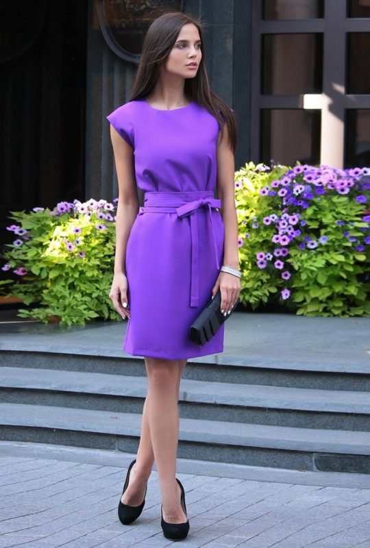 Girl in a purple cocktail dress with a bow Girl in a purple cocktail dress with a bow