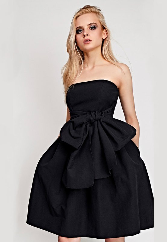 Girl in a black cocktail bandeau dress with a full skirt Girl in a black cocktail bandeau dress with a full skirt