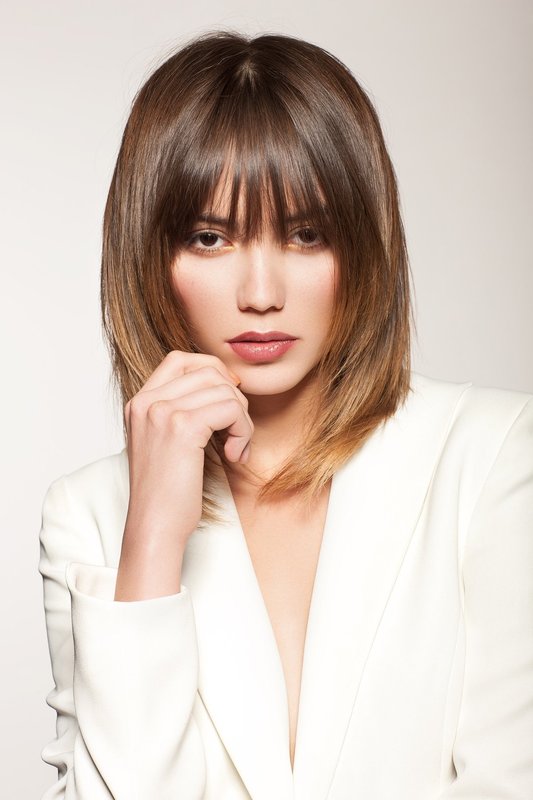 Girl with a haircut ladder and straight bangs