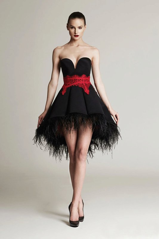 Girl in a cocktail dress with feathers on the hem Girl in a cocktail dress with feathers on the hem