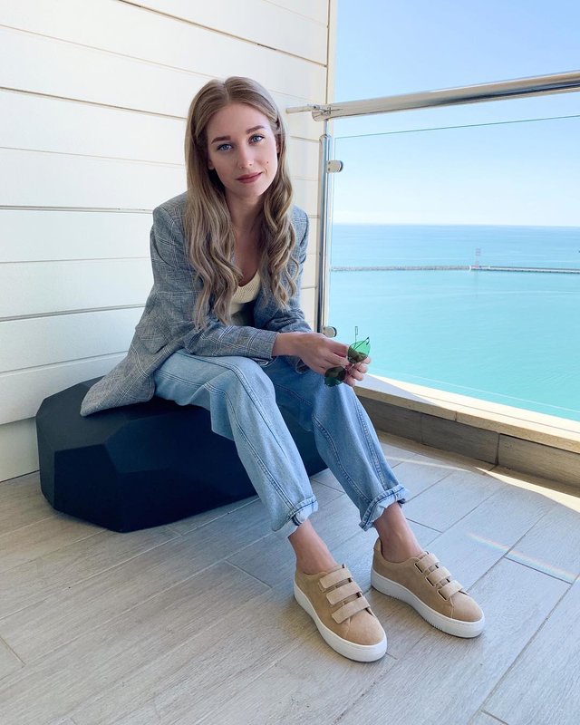 Christina Asmus in a jacket and jeans