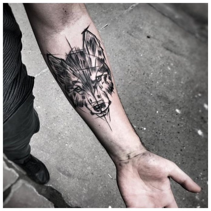 Wolf tattoo on a man’s hand Wolf tattoo on a man’s hand