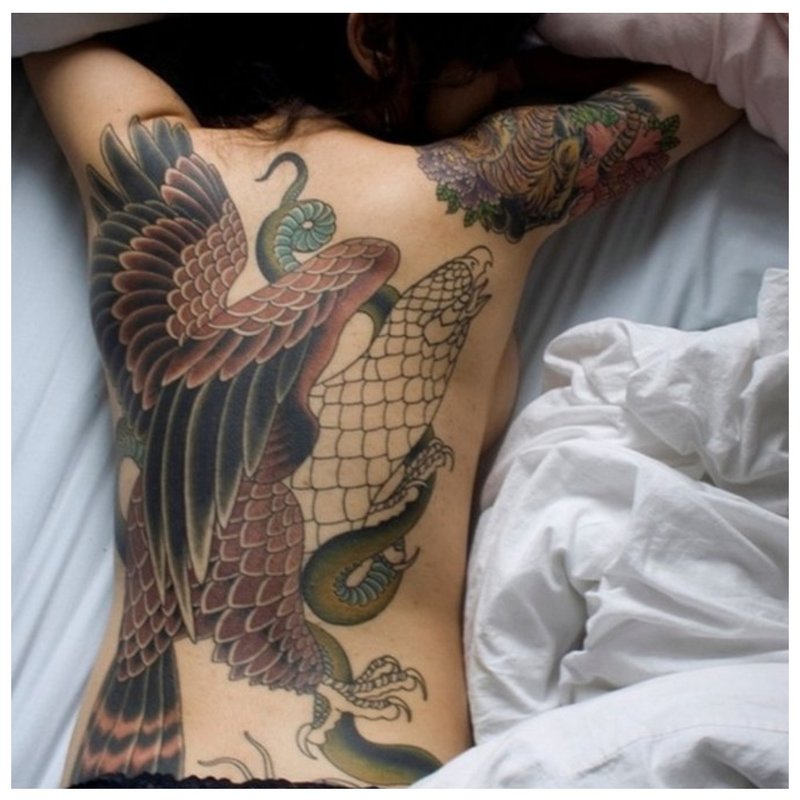 Girl with oriental tattoo on her back.