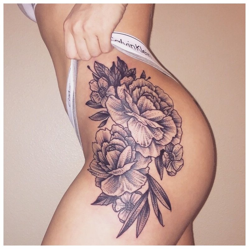 Sexy tattoo on the hip of a girl